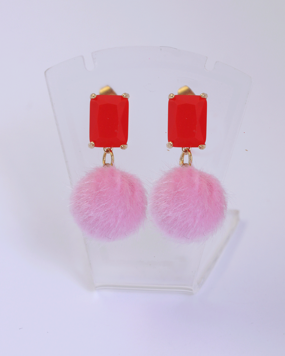 pink pompom and red stud earrings